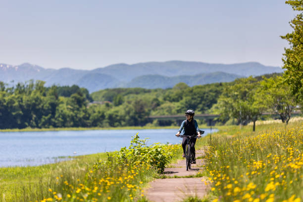 Woman riding bicycle in countryside nature
