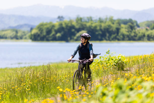 istock Woman riding bicycle in countryside nature 2154284590