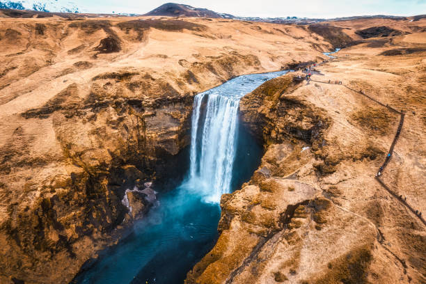 istock Powerful Skogafoss waterfall flowing with dry mountain in autumn at Iceland 2154284955