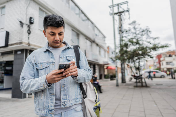 istock Young man using mobile phone in the city 2154285102