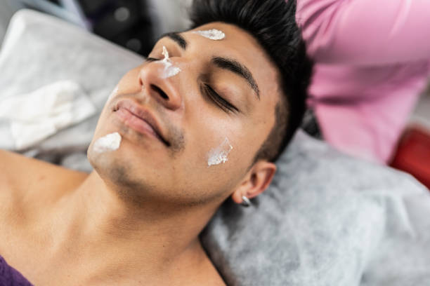 istock Young man having facial treatment at spa 2154285204