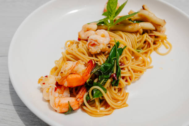 istock Stir-fried spaghetti with seafood on a white plate 2154285243