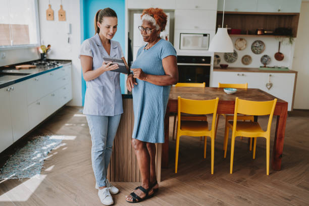 istock Home care healthcare professional using digital tablet 2154286415