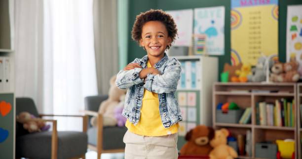 istock Smile, face and boy in classroom for education, learning and ready for morning kindergarten. Happy, school and portrait of child or student with knowledge, studying and pride for academic lesson 2154290475