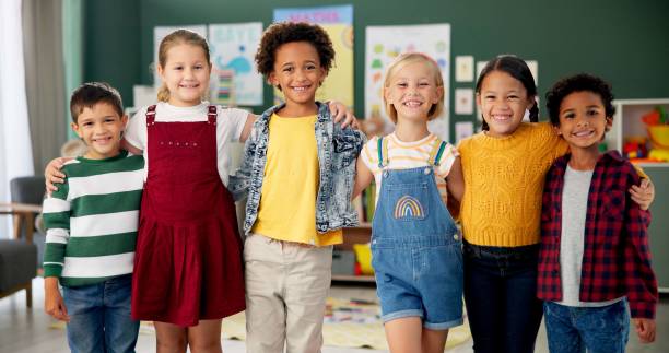 istock Children, diversity and kindergarten standing in class, bonding and education support with friends or students. Childhood, development and growth with community, innocent and learning environment 2154290538