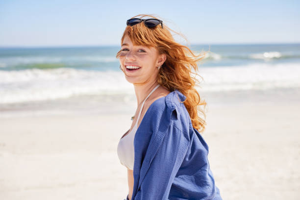 istock Smiling curvy woman enjoying summer at beach 2154293891