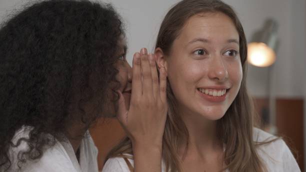 istock Two female friends having smile with good feeling on white bed 2154297905