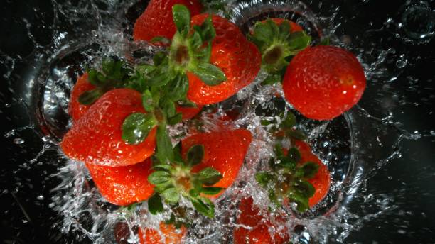 istock Freeze motion of strawberries falling into water 2154299680