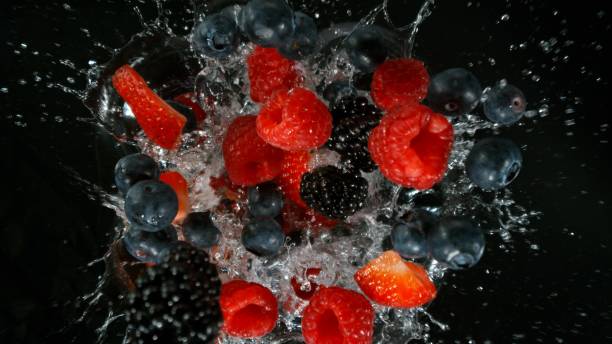 istock Freeze motion of various berries falling into water 2154299739