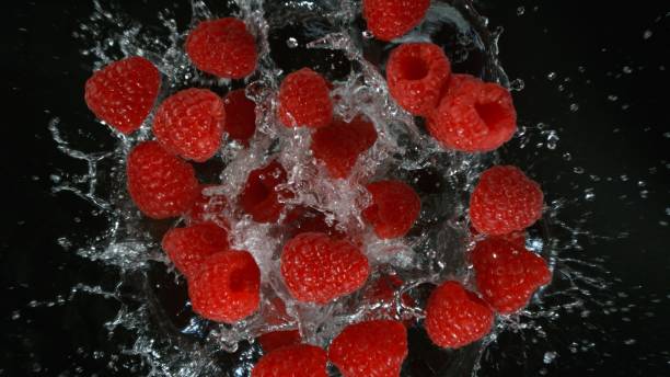 istock Freeze motion of various berries falling into water 2154299758