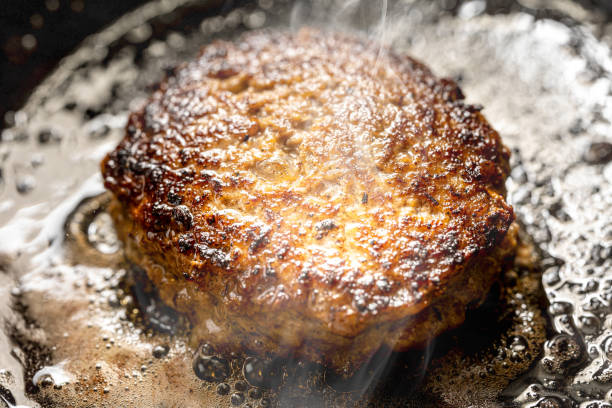 istock hamburger cooked in a frying pan 2154304196