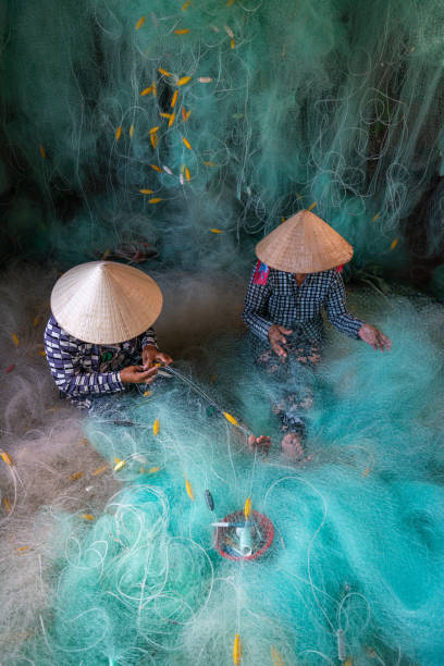 istock Women knitting turquoise fishing net net 2154306506