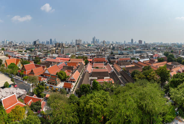 A picture of the rooftops of the Pom Prap Sattru Phai district of Bangkok, with the high rises at the far end.