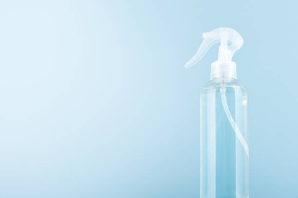 istock Eco friendly cleaning tools spray bottle with flying green leaves, bubbles, sun rays on blue background. Concept of eco home cleaning. Environmentally friendly home and office cleaning. Space for text 2154308908