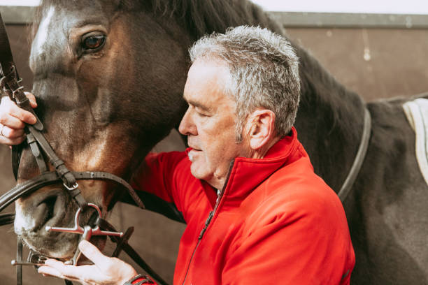 istock Senior man enjoying horseback riding hobby 2154313930