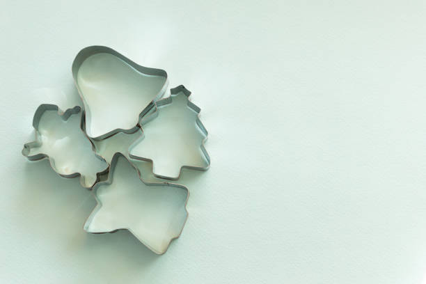 metal molds for gingerbread cookies on a light blue background, Christmas