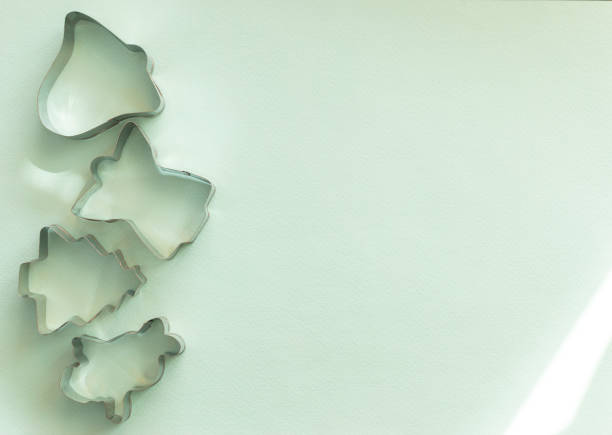 metal molds for gingerbread cookies on a light blue background, Christmas, copy space