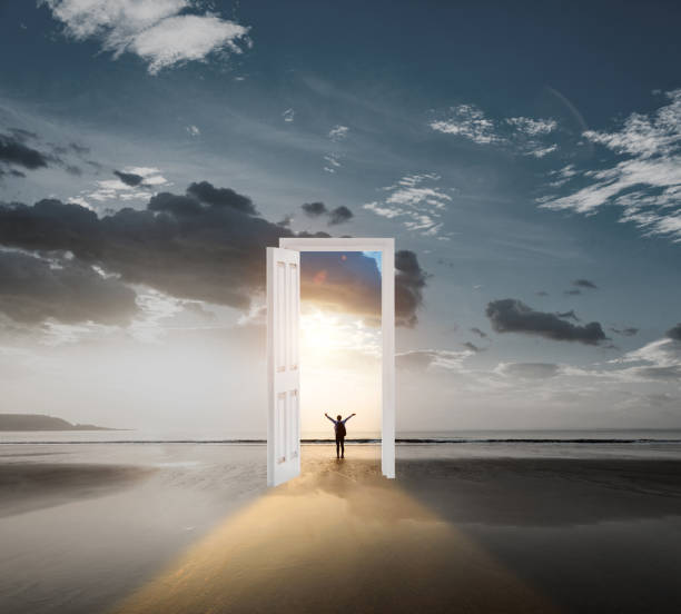 Men standing on the beach with a door