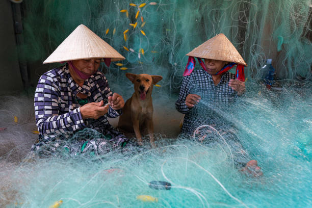 istock Women knitting turquoise fishing net net 2154315965