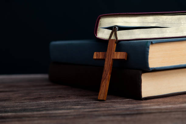 istock Bible and religious cross on wooden table 2154316000