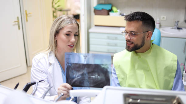 istock Dentist showing the x-ray to her patient 2154320079