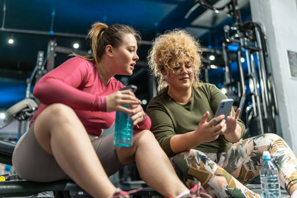 istock Two plus-size women embrace their bodies as they engage in a challenging workout 2154321308