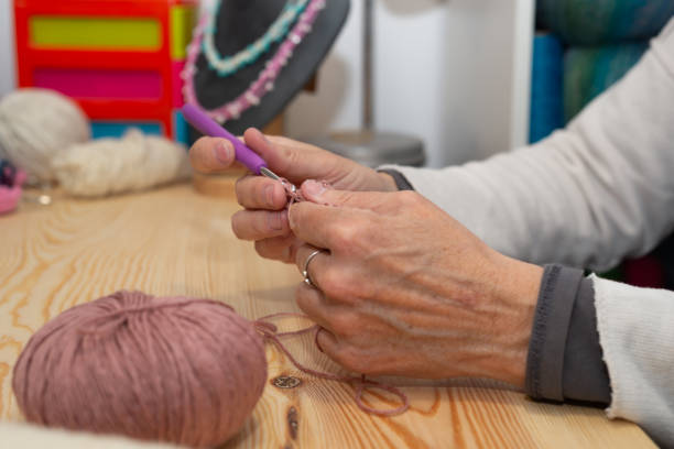 istock Side view of female hands crocheting. 2154326265