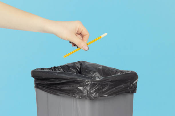 istock throw velor eyelash applicator in trash, outstretched hand with velor eyelash applicator in trash can 2154327004