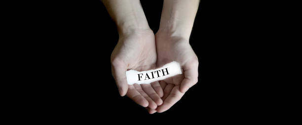 Person hands holding cupping paper message for Faith