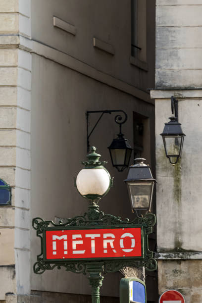 Paris France metro subway entrance featuring classic public transportation sign in urban setting