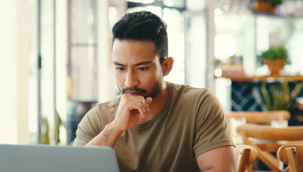 Coffee shop, thinking and business man on laptop for remote work, typing email and networking. Freelance, restaurant and person working on computer in cafe for internet, research project and proposal