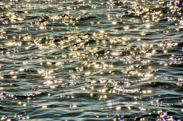 istock The water is calm and the sun is shining on it, creating a beautiful reflection 2154331630