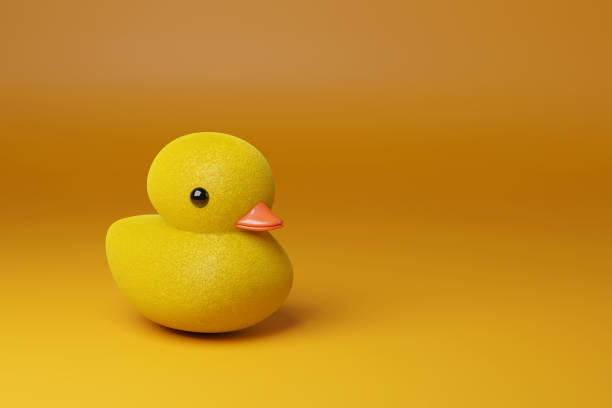 istock Toy duckling on yellow background with copy space. 3d illustration. 2154332795
