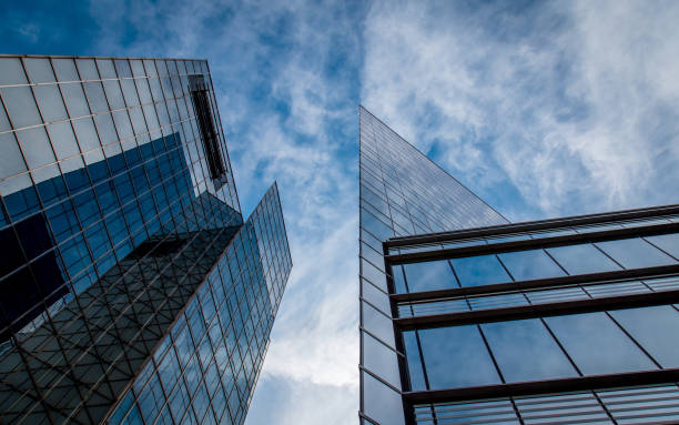 Tall glass skyscrapers against a blue sky with white clouds