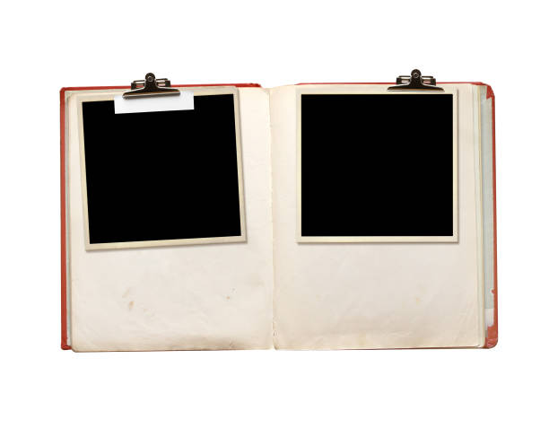 istock Old book, photo frame with paper tag attached with a vintage clip. Nostalgic scrapbooking style. Retro photo album and blank photos. Mock up template. Copy space for text. Isolated on white 2154334322