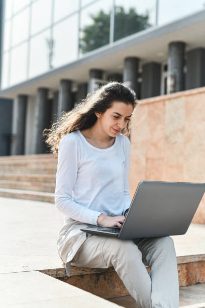 istock Female Web Designer Working On Laptop In City Center 2154339892