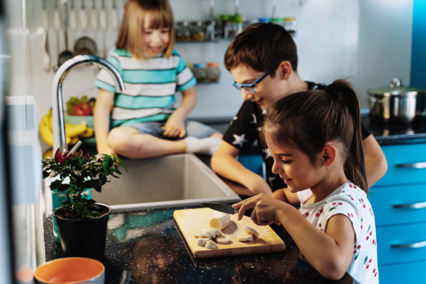 istock Siblings cooking together in a stylish kitchen 2154342775
