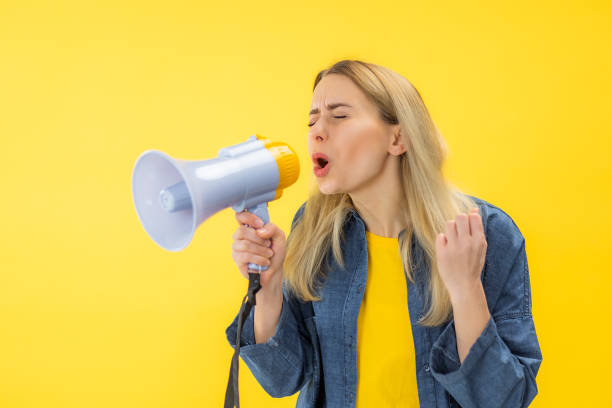 istock Beautiful woman shouting through megaphone 2154344064