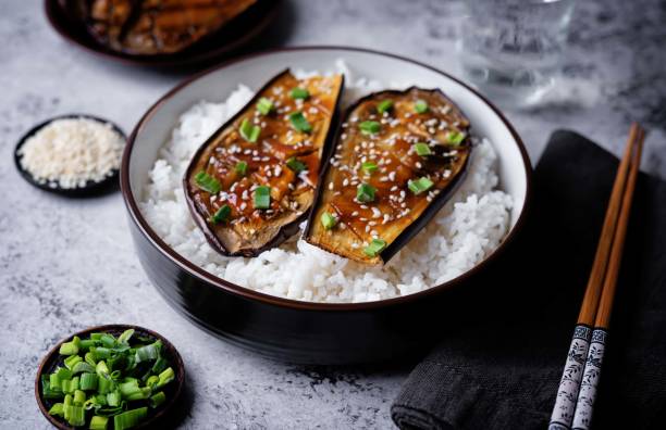 istock Teriyaki sauce eggplant slices with rice in a bowl 2154347221