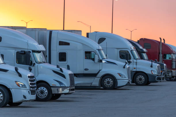 istock Rows of Trucks Parked at a Rest Stop Against a Beautiful Sunset 2154348633