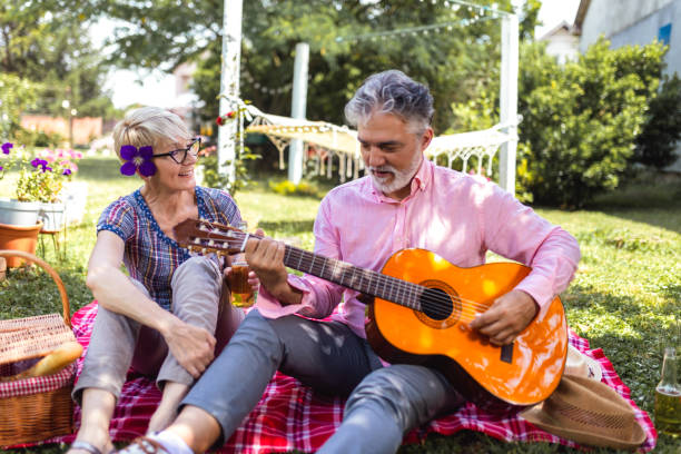 istock Loving mature couple with guitar in park 2154350875