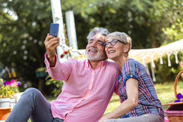 istock Modern elderly couple taking selfie on smartphone, 2154351057