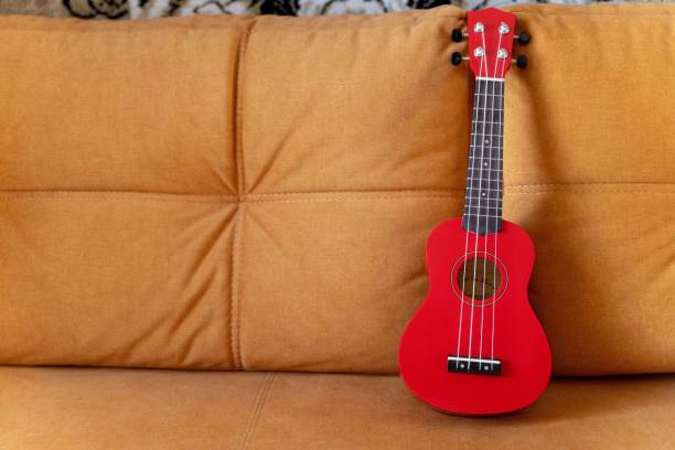 istock A red ukulele placed on top of a couch 2154351908