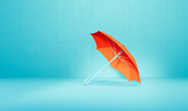 Coral colored umbrella over background.