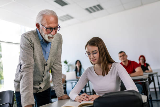 istock Students listening to an older high school teacher. 2154352209