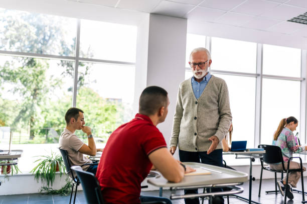 istock Students listening to an older high school teacher. 2154352264