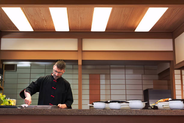 istock A chef is cooking in his restaurant's kitchen 2154353300