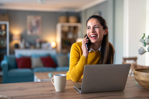 istock Happy smiling woman having fun conversation over mobile phone 2154358434