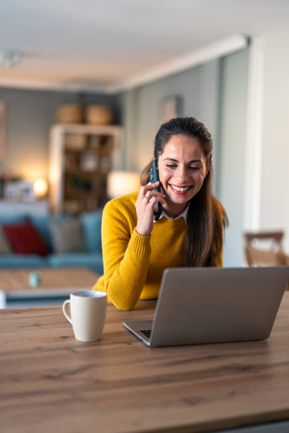istock Woman talking over cellphone in a home office 2154358466