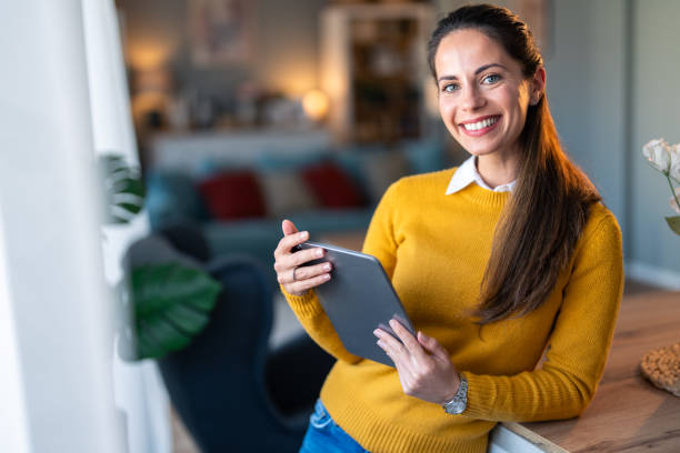 istock Smiling confident businesswoman looking at camera and holding digital tablet, posing for a business portrait photo 2154358914